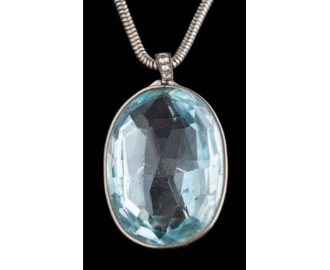An oval blue topaz single-stone pendant: the faceted oval pale blue topaz approximately 37mm long x 27mm wide in spectacle fr