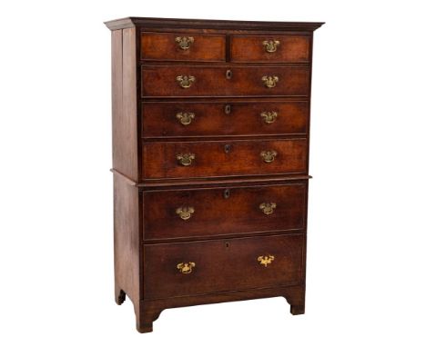 An 18th Century oak tallboy:, the upper part with a moulded cornice, containing two short and three long drawers, the lower p