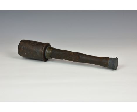 A WWI German stick grenade, of typical form in relic condition, retaining belt clip, deactivated (inert), 14in. (35.5cm.) lon