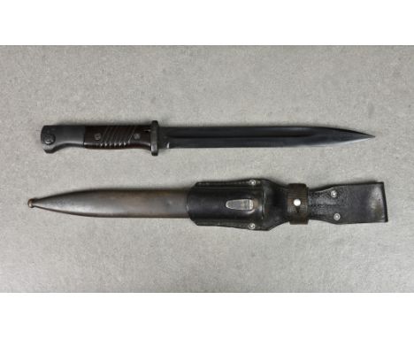 A Second World War German K98 bayonet with scabbard and frog, the bayonet with fullered single edged 250mm. blade, maker's ma