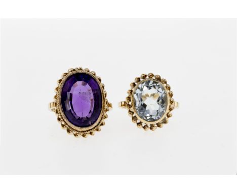 Two 9ct gold gem set rings, both with rope twist settings, one with an oval step cut amethyst, size I; the other with a blue 