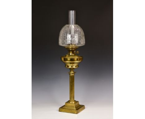 A late 19th century brass column oil lamp, the clear floral etched glass shade above a pierced burner, stamped 'Best British 