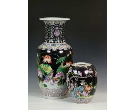 A Chinese porcelain black ground large baluster vase, second half 20th century, painted in famille rose enamels with birds an