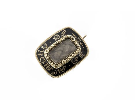 A Regency 15ct gold and enamel mourning brooch, the convex plaque with a central plaited hair inset within a lettered border,