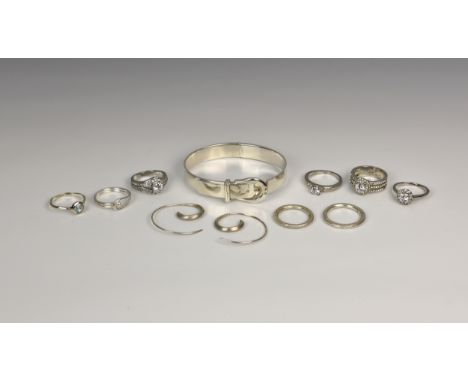 A collection of silver jewellery, to include a silver hinged bangle with buckle detailing, a pair of silver earrings and eigh