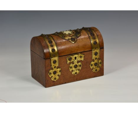 An antique walnut stationary box with domed lid, having ornate studded brass mounts and central vacant bone shield cartouche,