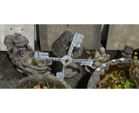 A small collection of composite stone garden ornaments, comprising of a windmill, 24in. (61cm.) high; squirrel with wheel bar