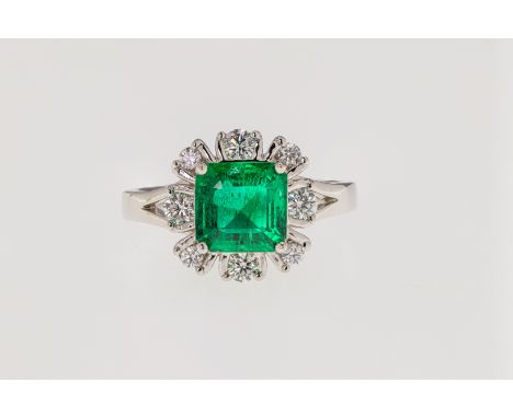 An 18ct while gold, oil free emerald and diamond, featuring a step cut emerald weighing approximately 1.52ct and held within 