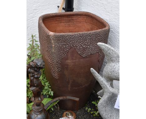 A large glazed terracotta garden planter, of elongated tapering square form with naturalistic decoration, 27in. (68.5cm.) hig