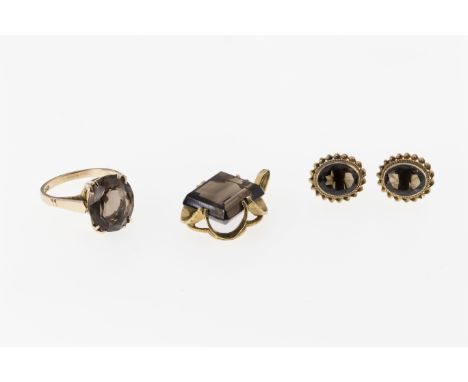 Three pieces of 9ct gold and smoky quartz jewellery, comprising a pendant with step cut stone; a ring with oval cut stone, si