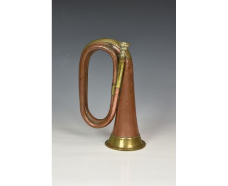 A 1916 WWI military issue USA cavalry copper & brass bugle by J W York & Sons, of typical form, stamped '1916 J W YORK & SONS