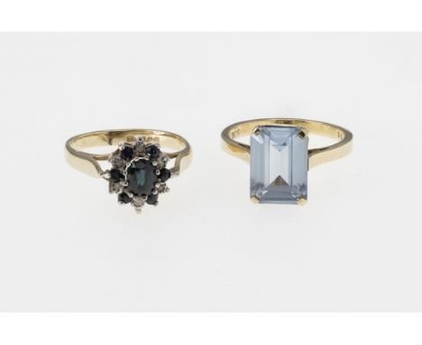 Two 9ct gold rings, one set with an emerald cut topaz, L; the other with a sapphire and diamond cluster, size K. (2) 