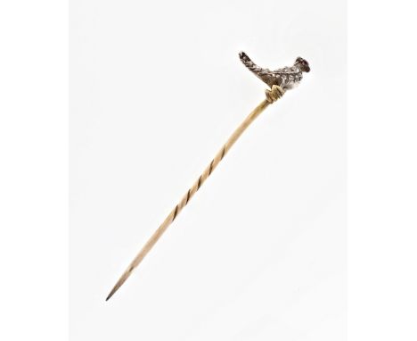 An antique diamond and ruby stickpin, featuring a miniature bird studded with rose cut diamonds, with ruby eyes, pin top appr