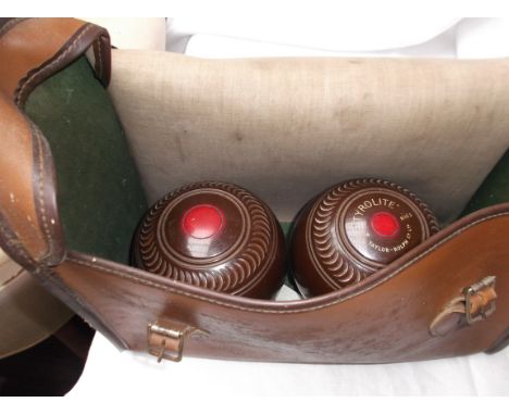Pair of brown tyrolite lawn bowls with steel measure all in light brown plastic carrying case
