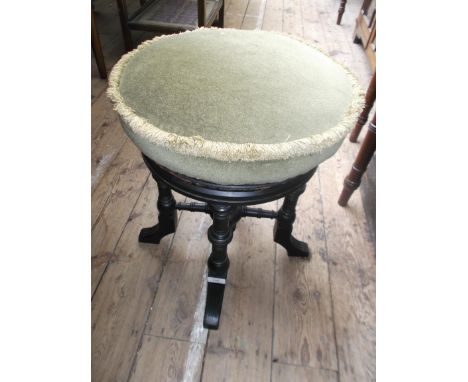 Dark oak piano stool, the revolving padded seat upholstered in light green dralon