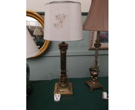 Brass corinthian column based table lamp with beige parchment shade