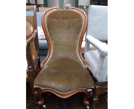 Victorian mahogany hoop backed nursing chair on pot castors, the padded seat and button back upholstered in gold dralon