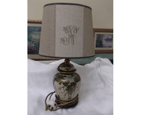 Green and gilt Oriental based table lamp with light brown parchment shade