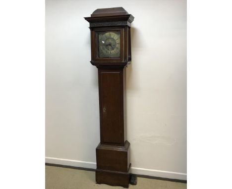 An oak cased long case clock, the caddy top with blind fretwork frieze over a plain main body, the eight day movement with sq