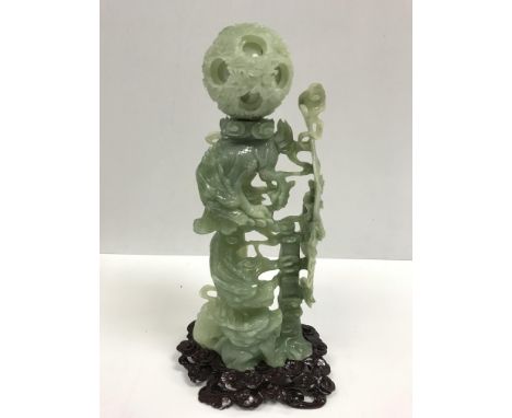 A 20th Century Chinese carved jade puzzle ball on three dragon stand, approx 36 cm high