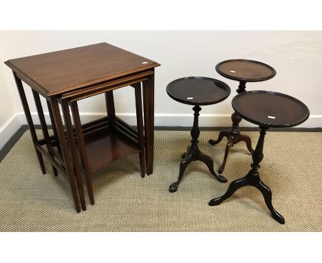 An Edwardian mahogany nest of three occasional tables, the plain tops with moulded edge on square tapered legs united by stre
