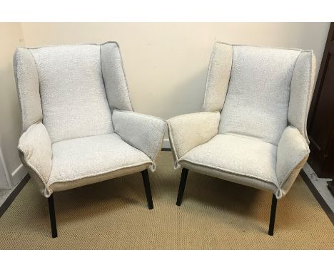 A pair of Ligne Roset "TOA" wing back armchairs on ebonised splayed supports designed by Remi Bouhaniche 103 cm high x approx