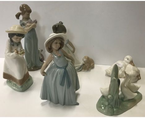 A collection of two Lladro figures "Girl with kittens" 21 cm high and "Girl in Summer dress" together with four Nao figures c