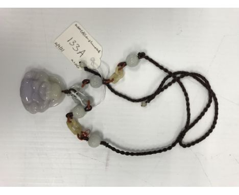 A mauve jade pendant as a seated smiling Buddha, 4.3 cm x 4.1 cm, on silk and jade chain link necklet