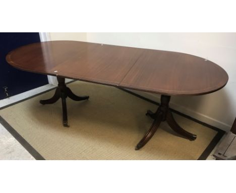 A 19th Century mahogany satinwood strung and cross banded fold over card table raised on square tapered legs to block feet 90