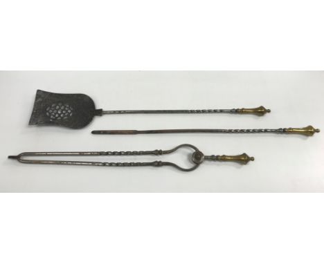 A set of three late 18th / early 19th Century brass-handled iron fireside tools of barley-twist form, comprising shovel, poke