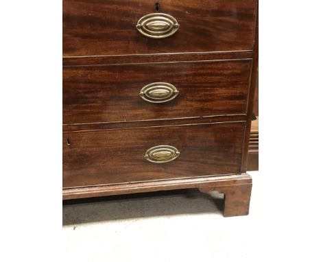 An early 19th Century mahogany linen press, the moulded cornice over two panelled doors enclosing five linen shelves on a bas