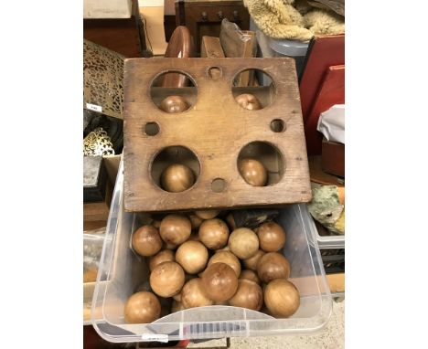 A set of four Taylor Rolff Co Ltd lawn bowls together with a collection of 55 treenware balls and a croquet trophy as a ball 