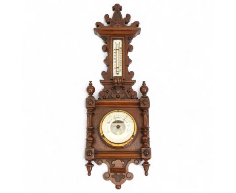 Early 20th century Edwardian aneroid barometer, in a mahogany case with scroll carving, turned finials and pendants, boxed me