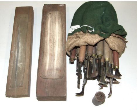 A collection of 28 silversmiths' tools and two sharpening stones.