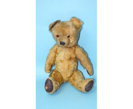 A large teddy bear, possibly Chad Valley, with vertically stitched nose, glass eyes, golden mohair plush and Rexine pads, ino