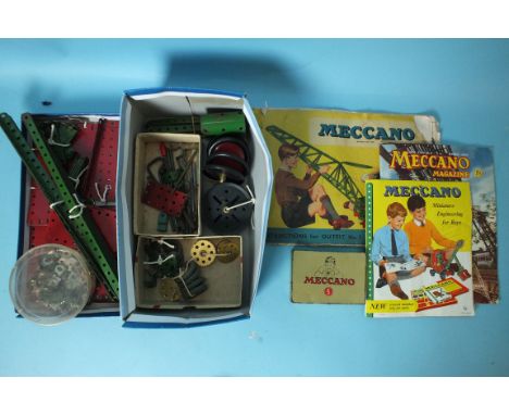 A quantity of red and green Meccano, with instructions for Outfit No.5, a Meccano magazine and leaflet.