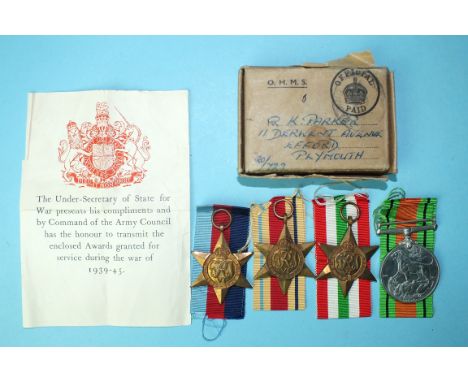 A WWII group of four medals: War Medal 1939-45, Africa and Italy Stars, with leaflet and box of issue addressed to R K Parker