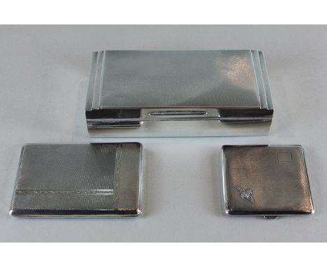 A George VI rectangular silver cigarette box with engine turned lid, Birmingham 1937, and two cigarette cases, one mounted wi