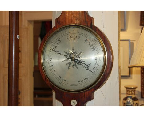 A 19th century rosewood wheel barometer and thermometer, J S Pelzini, 11 Beauchamp Street, Holborn, the silverized circular d