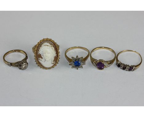 A shell cameo ring, two amethyst and diamond rings and two other rings 