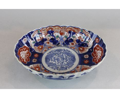 An early 20th century Imari oval dish decorated in the traditional colours (a/f), 24.5cm by 20cm