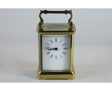 A brass carriage clock with Roman numerals, 14cm
