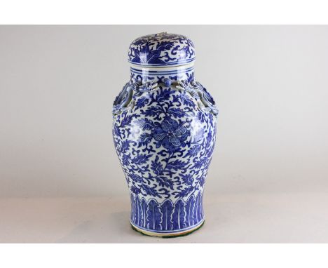 A Chinese blue and white porcelain vase and cover, baluster shape with two dragons and pearl to neck, decorated with scrollin