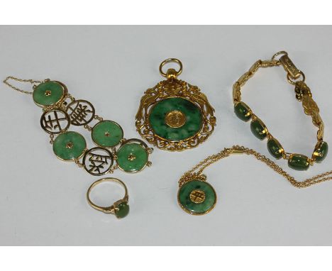 A Chinese gold mounted jade bracelet, two gold mounted jade pendants, a jade bracelet and ring 