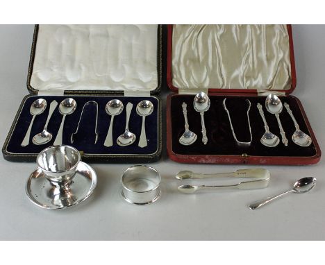 A cased set of six George V silver coffee spoons and tongs; another set of five apostle spoons and tongs, an egg cup, napkin 