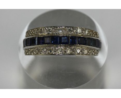 A sapphire and diamond half hoop ring, channel set with a central band of calibre cut sapphires between rows of diamonds