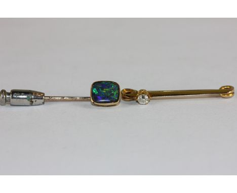 A diamond single stone bar brooch and a black opal doublet stick pin 