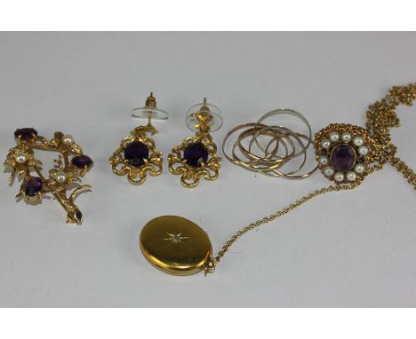 An amethyst and pearl brooch in 9ct gold and a similar dress ring, a pair of amethyst drop earrings, a multi band gold ring, 