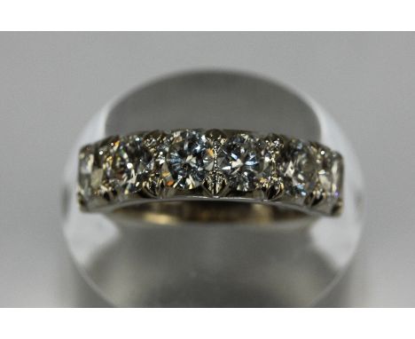 A diamond five stone half hoop ring, shared claw set with uniform round brilliant cuts in 18ct white gold 