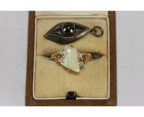 An opal and diamond ring in 18ct gold, a silver and hematite pendant